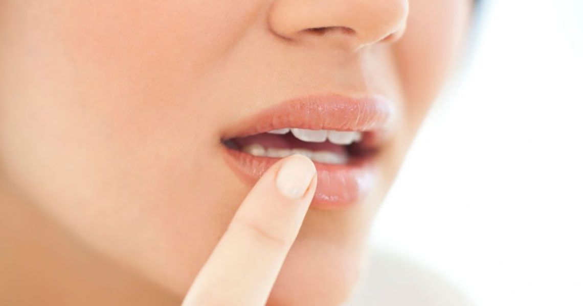 Woman applying moisture to her lips