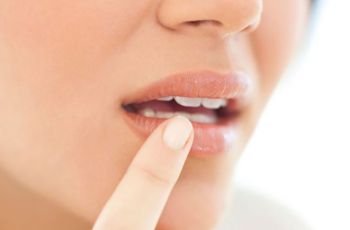 Woman applying moisture to her lips